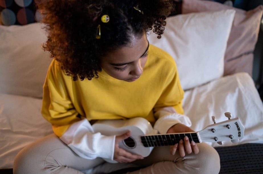 playing a guitar is artistic and creative hobby your child needs