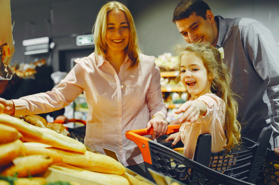 a child and parents in the supermarket